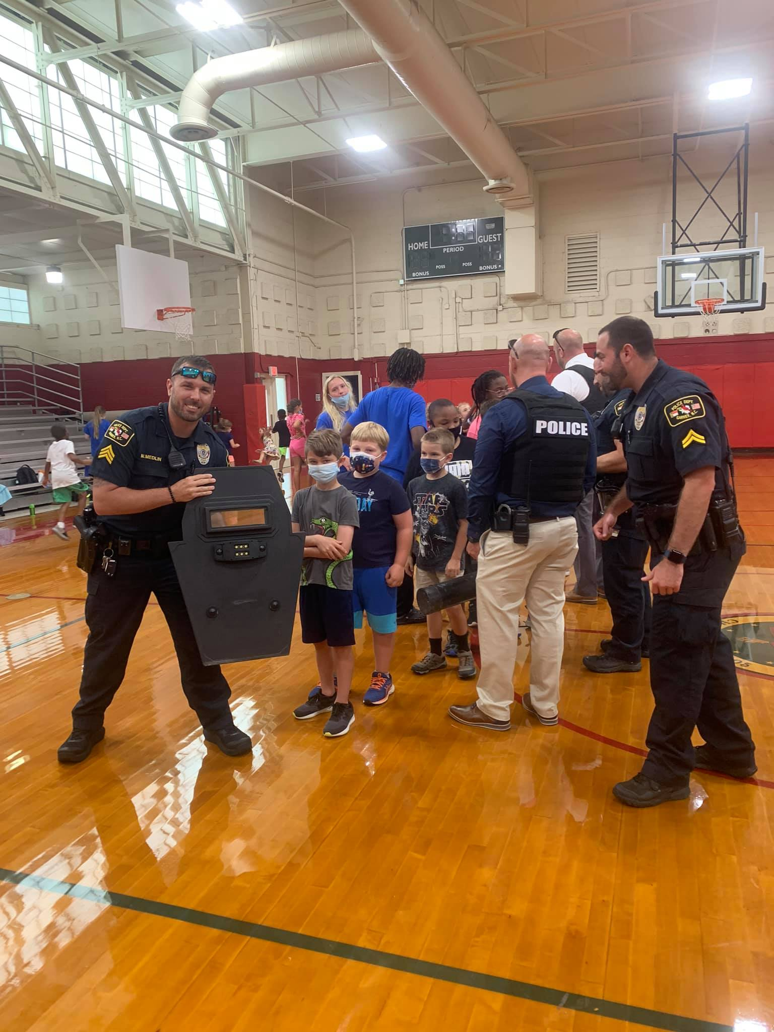 Officers showing children police equipment in an interactive, welcoming session